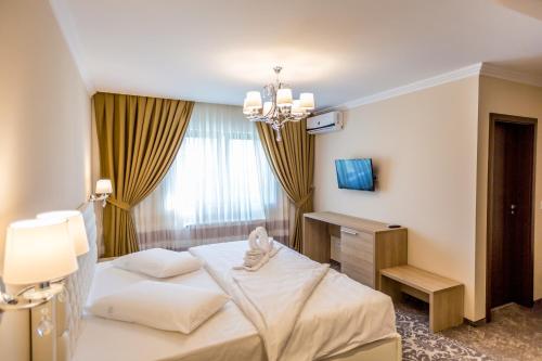 Postel nebo postele na pokoji v ubytování J'adore Boutique Hotel