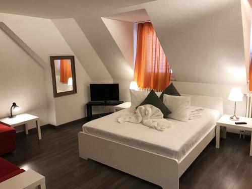 a bedroom with a white bed and a television at INSIDE Five in Zürich