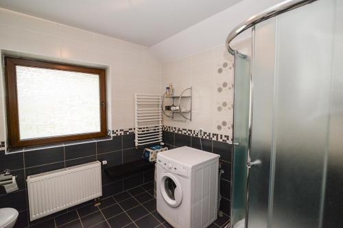 a bathroom with a toilet and a shower at Sweet Family Home in Cieszyn