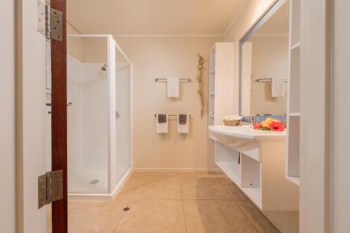 a bathroom with a shower and a sink at Sunset Resort in Rarotonga