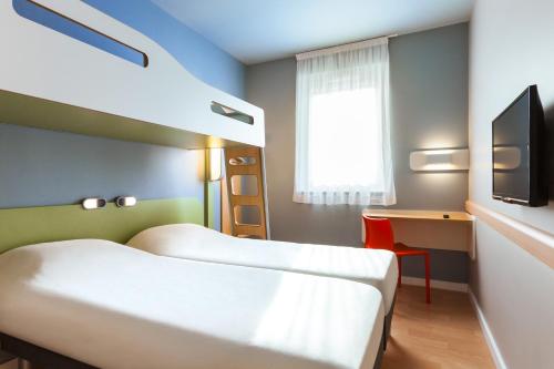 Tempat tidur dalam kamar di ibis budget Sens