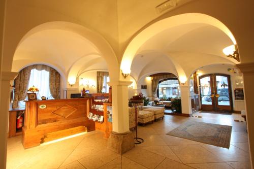 a living room with arched ceilings and a room with a couch at Hotel Trieste in Cortina dʼAmpezzo