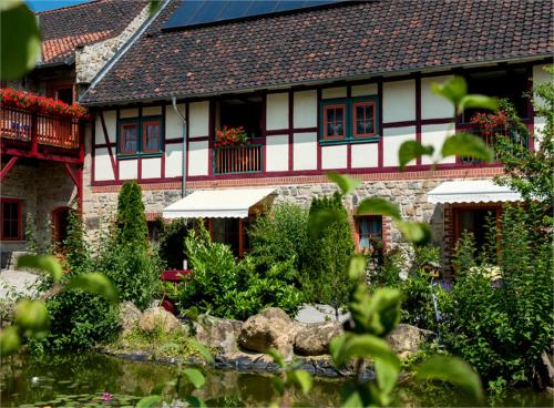 a house with a garden in front of it at Hotel Gut Voigtlaender in Blankenburg