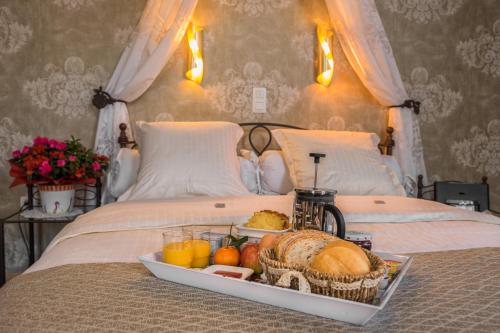 a tray of food on top of a bed at Bariseele B&B in Bruges