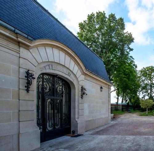 a building with a large black door on it at Les Suites du Champagne de Venoge in Épernay