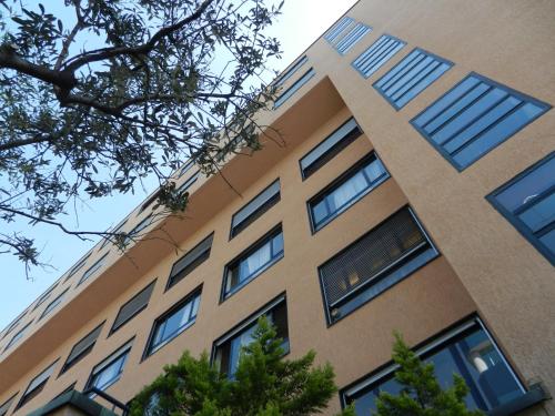 a tall building with windows on the side of it at Hotel Ceresio in Lugano