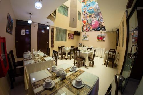 a restaurant with tables and chairs in a room at UTASA VILLA REAL inn in Puno