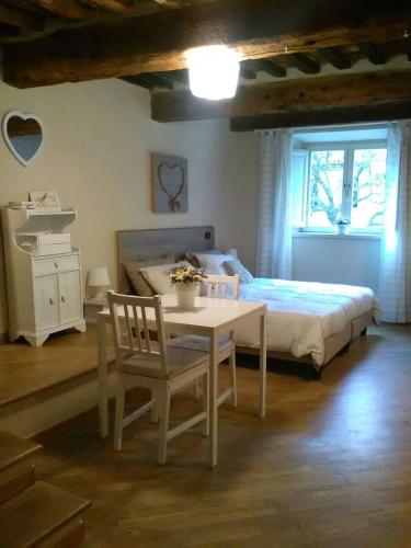 1 dormitorio con 1 cama, mesa y sillas en Suite Sofia, en Lucca