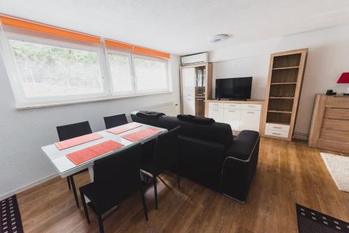 a living room with a dining room table and chairs at Apartment Berglez in Škofja Loka