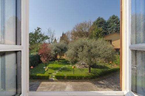 an open window with a view of a garden at Il Giardino Del Pettirosso in Lucca