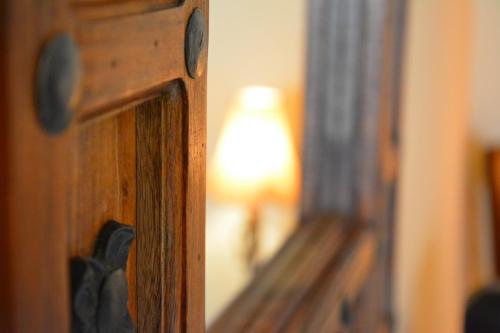 a mirror with a reflection of a lamp in a room at Gästehaus Turm Wachau in Weissenkirchen in der Wachau