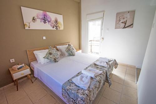 a bedroom with a large bed and a table at Mare Civitas Apartments in Chania Town