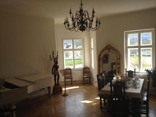 Sala de estar con piano, mesa y espejo en Sarah's Altstadt Oase Salzburg, en Salzburgo