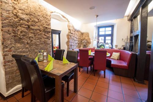 a restaurant with a table and chairs and a couch at Leipziger Hof in Fulda