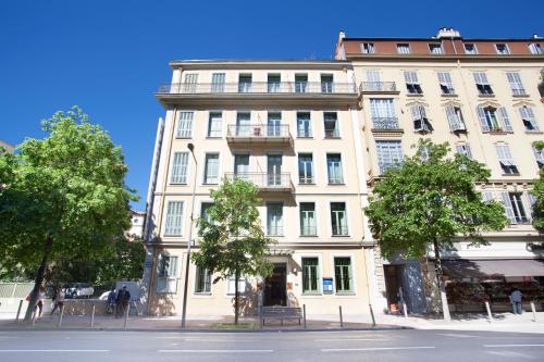 un grande edificio bianco su una strada cittadina di Odalys City Nice Le Palais Rossini a Nizza