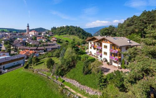 an aerial view of a house on a hill at Appartements Plattnerhof in Castelrotto