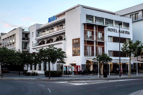 a white building on a city street with at Hotel Marina in Roses