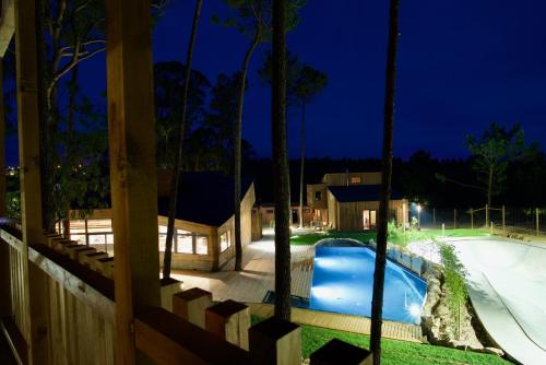 a house with a swimming pool at night at Bukubaki Eco Surf in Ferrel