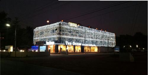 a large building is lit up at night at Ocean Crest Hotel in Colva