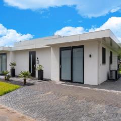 Villa with covered terrace and jetty on the water