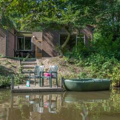 Restyled bungalow on the water with its own rowing boat, in a holiday park