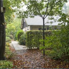 Cozy house with a fireplace in a holiday park in a natural area