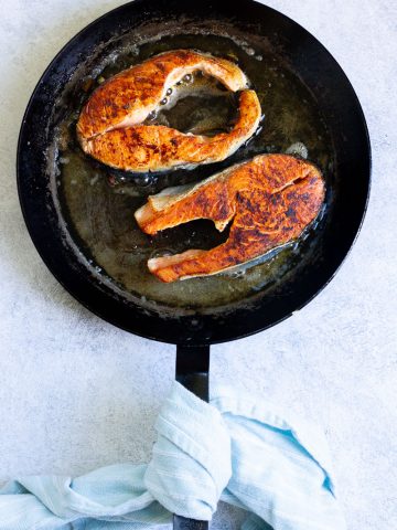 salmon steaks in a pan.