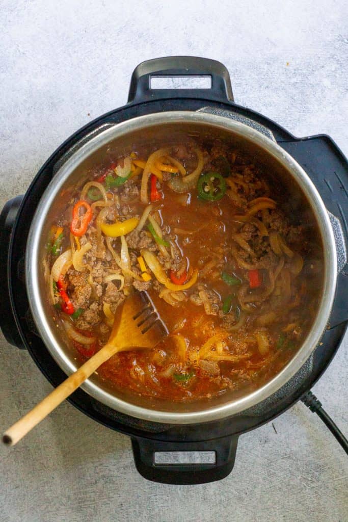 Adding the Beer to the Venison Chili.