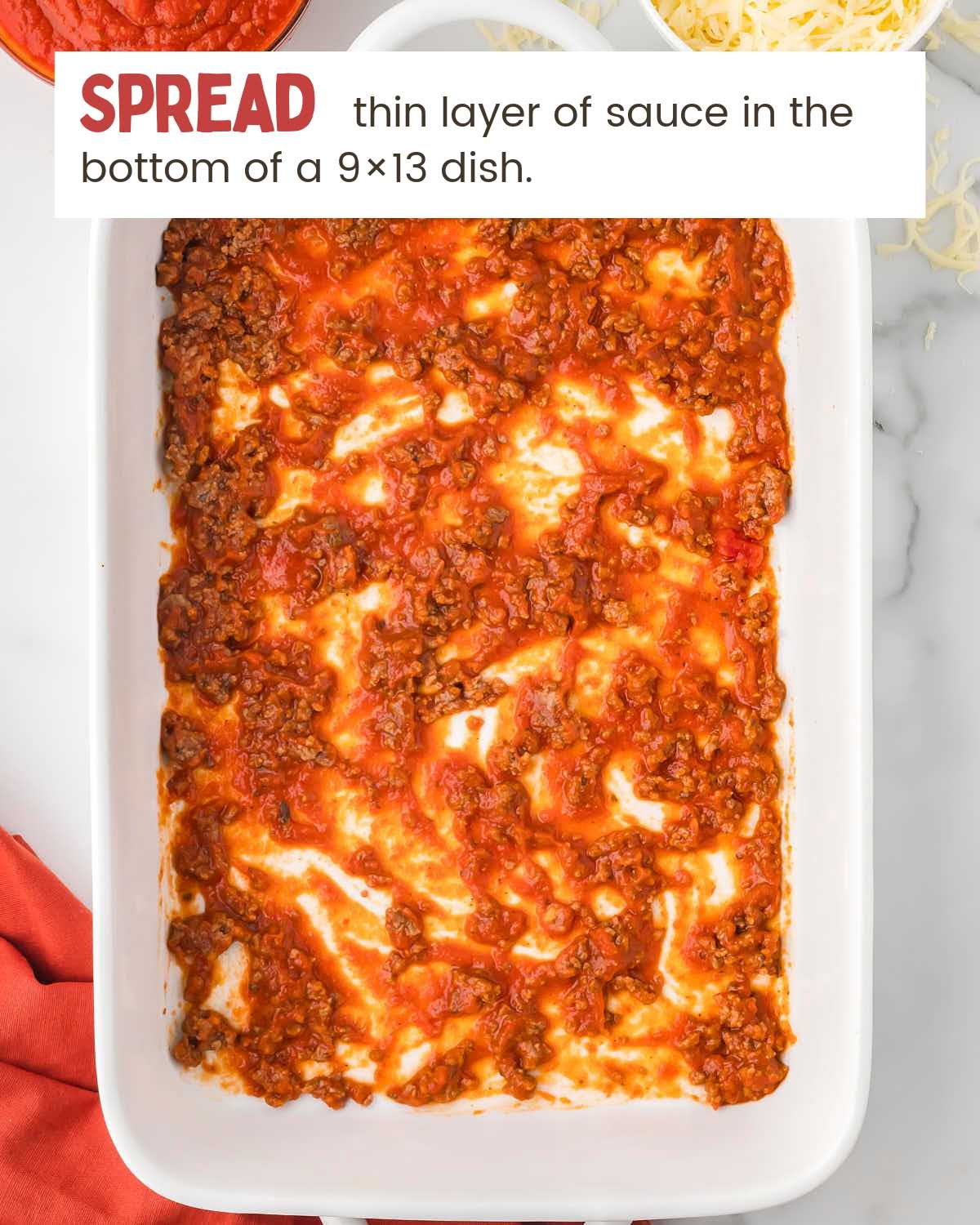 a thin layer of meat sauce in a baking dish.