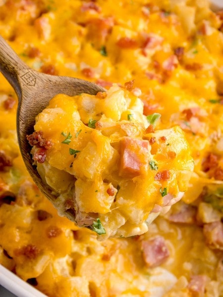 Ham and Potato Casserole with a wooden spoon.