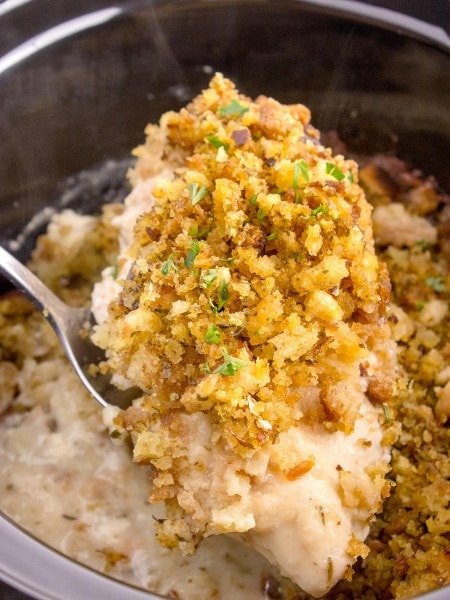 Chicken and Stuffing on a serving spoon in a Crockpot.