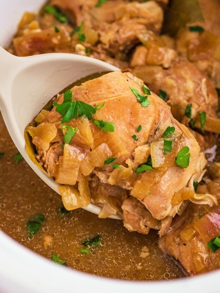 Topdown view of a serving spoon filled with Adobo Chicken in the Slow Cooker.