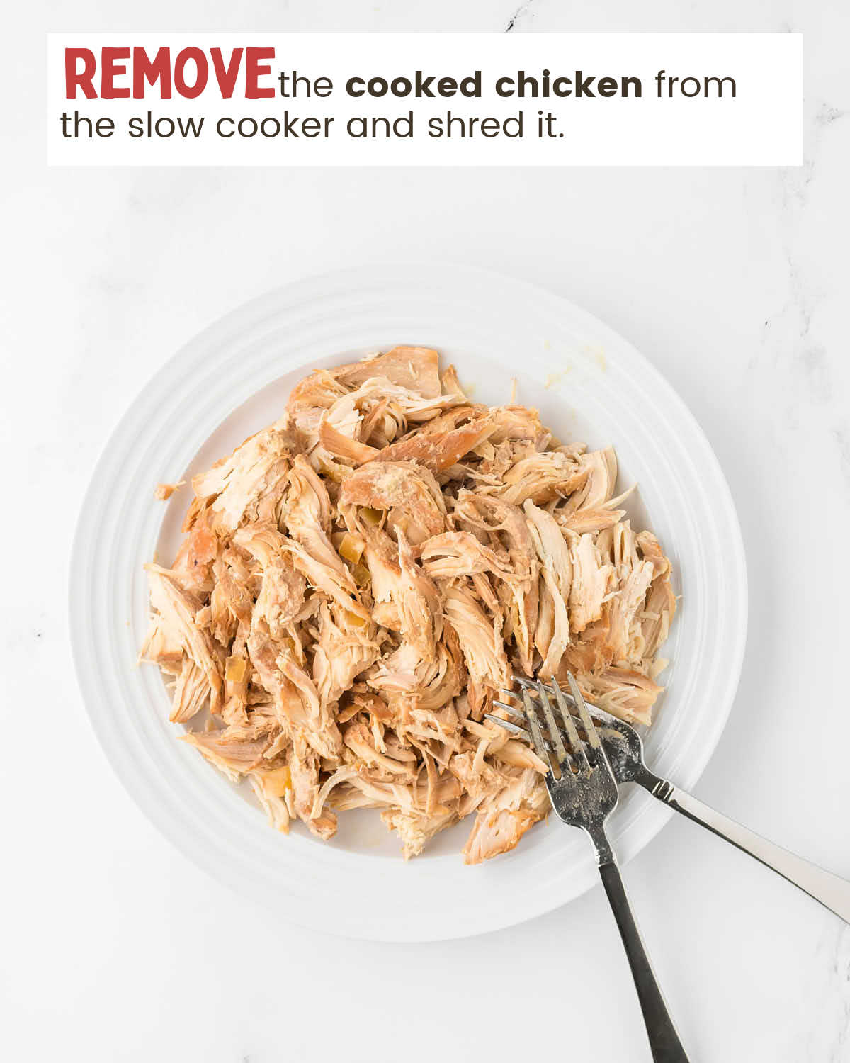 Top view of a plate with two forks shredding chicken with instructions in a text box.