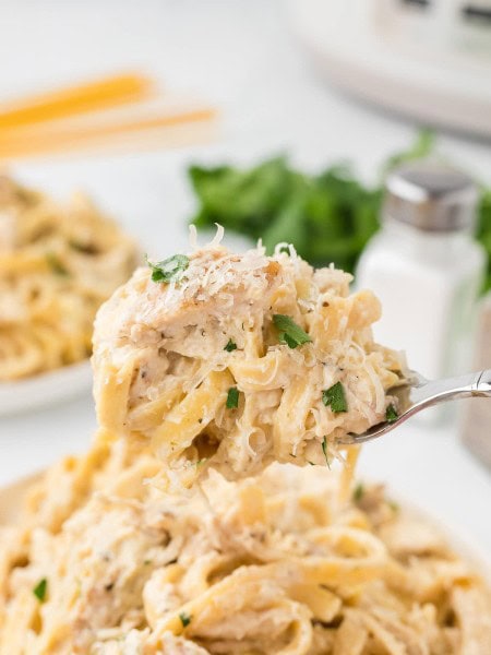 A spoonful of creamy Crockpot Chicken Alfredo.