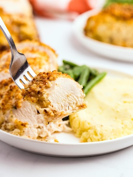 A forkful of Parmesan Crusted Chicken.