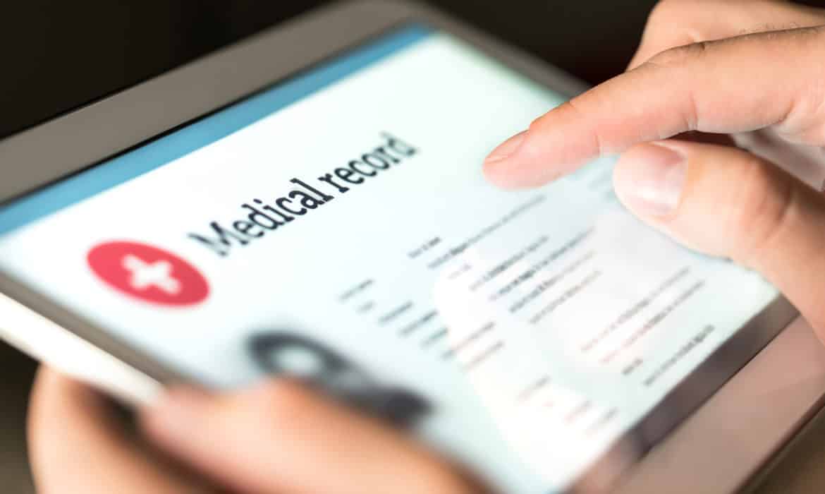 Electronic medical record with patient data and health care information in tablet. Doctor using digital smart device to read report online. Modern technology in hospital