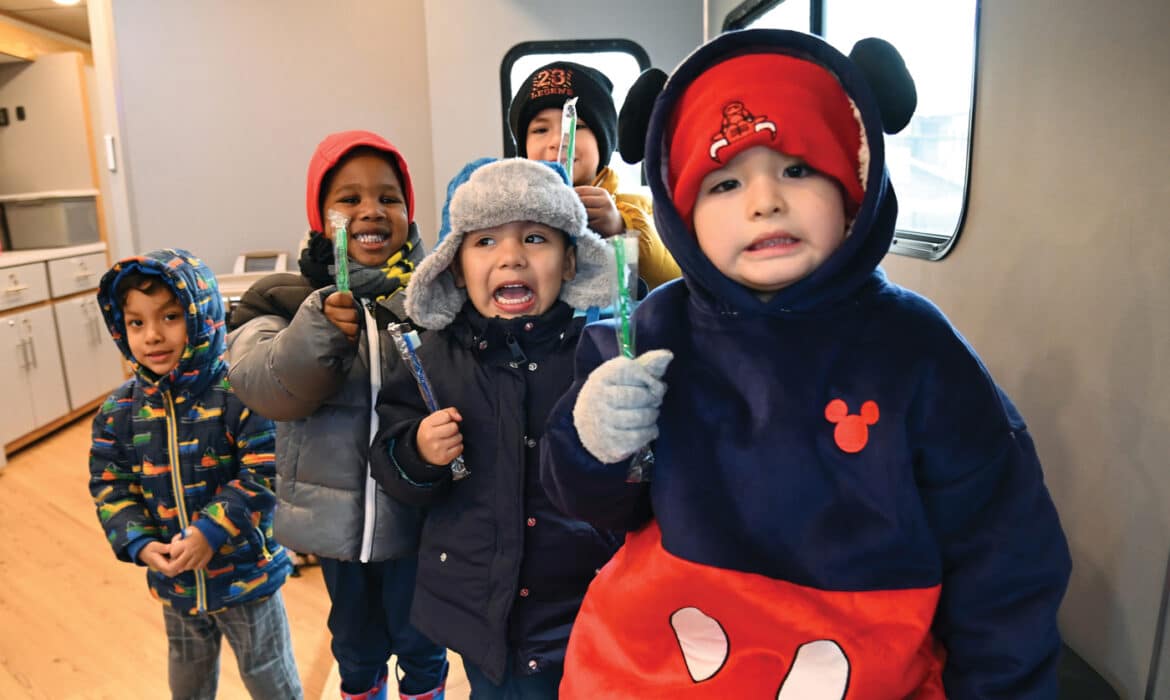 Mobile Care Chicago dental van. Children hold their new toothbrushes inside the Mobile Care Chicago’s Dental Van. The van visited Pathways To Learning Child Care Center (6535 S. Kedzie Ave.) in Chicago on Jan. 11, 2024.