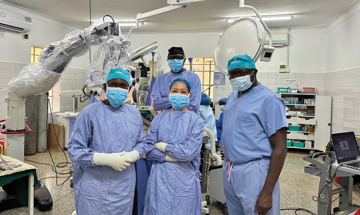 Sandi Lam, MD (center) along with physicians on the CURE Uganda team in the operating room.