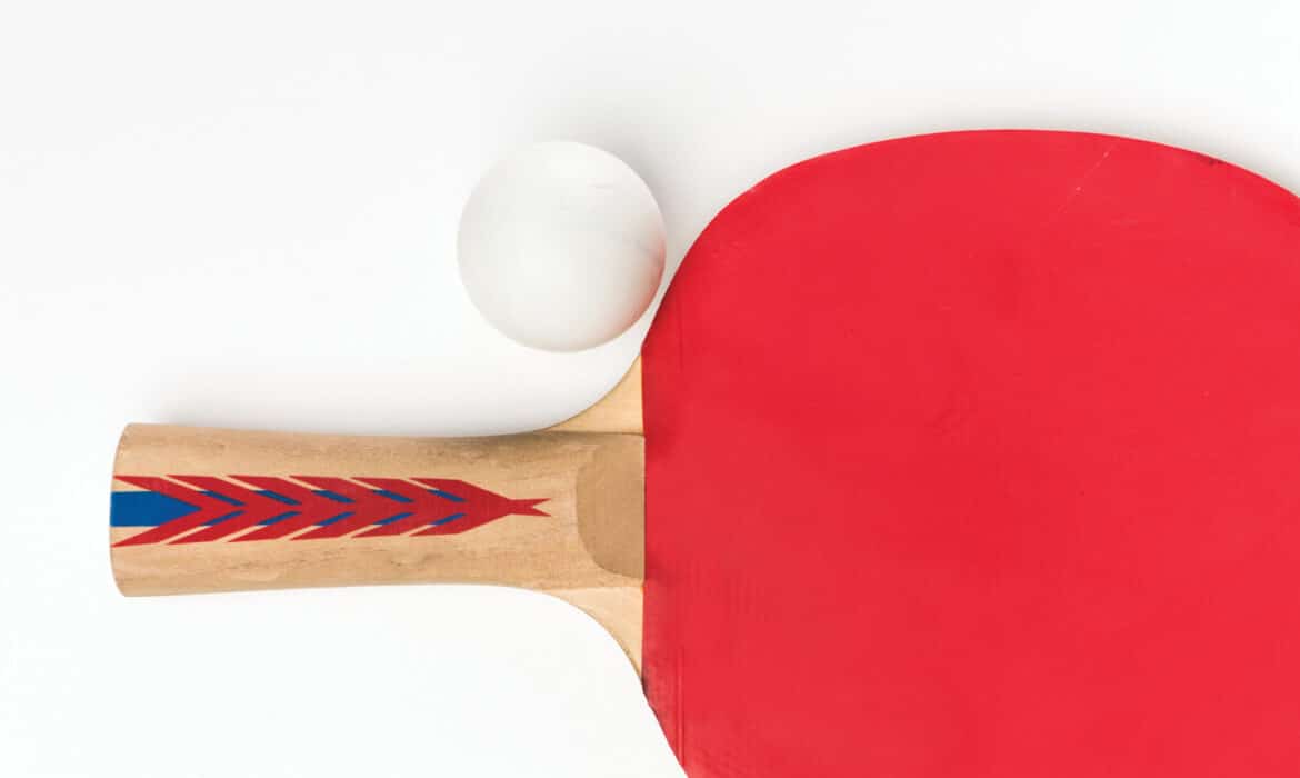 Paddle and ball representing table tennis as a treatment to combat Parkinson's disease