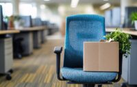 Fired employee's cardboard box sitting on an office chair