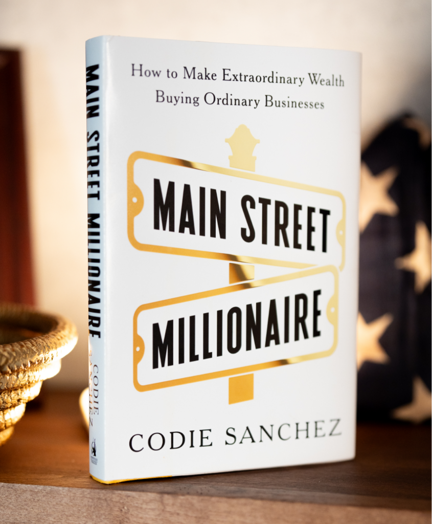 The 'Main Street Millionaire' book by Codie Sanchez, standing on a shelf.