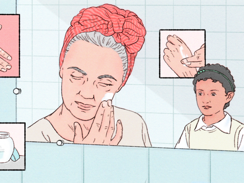 An illustration of the reflection on a bathroom mirror. An older woman is applying cream to her face, with her tied back in a scarf around her ahead. In the background, a young girl watches attentively. There's a pale blue tile behind them. In little inserts around the image are close ups of the cream being applied.