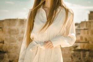 woman in white long sleeve dress wearing black sunglasses