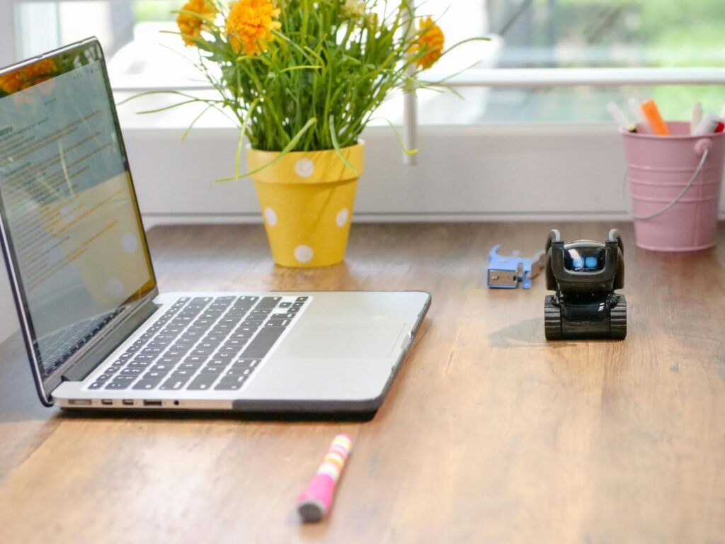 laptop on a desk at home showing online education