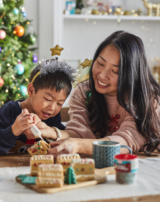 Two women smiling and eating Chocolate Chip Christmas Pudding Cookies