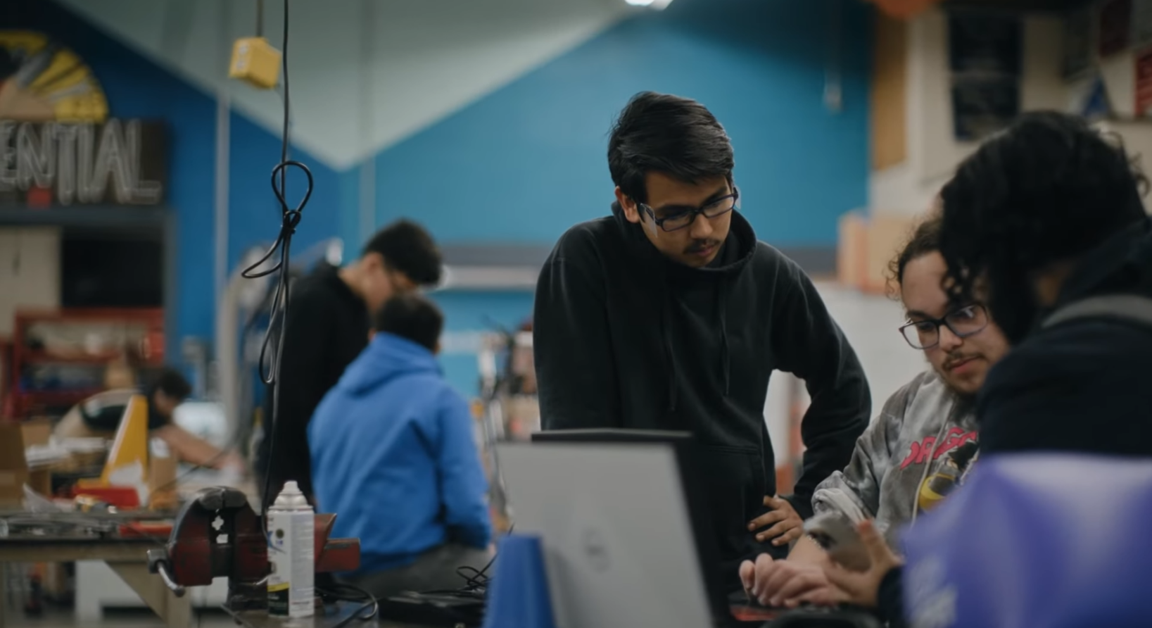 Robotics students looking at computer