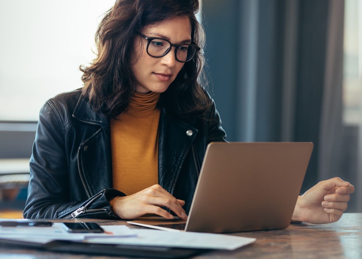 Woman working on a laptop in an office