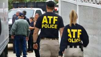 Two federal agents from behind wearing "ATF POLICE" shirts. | APEX / MEGA / Newscom/DFBEV/Newscom