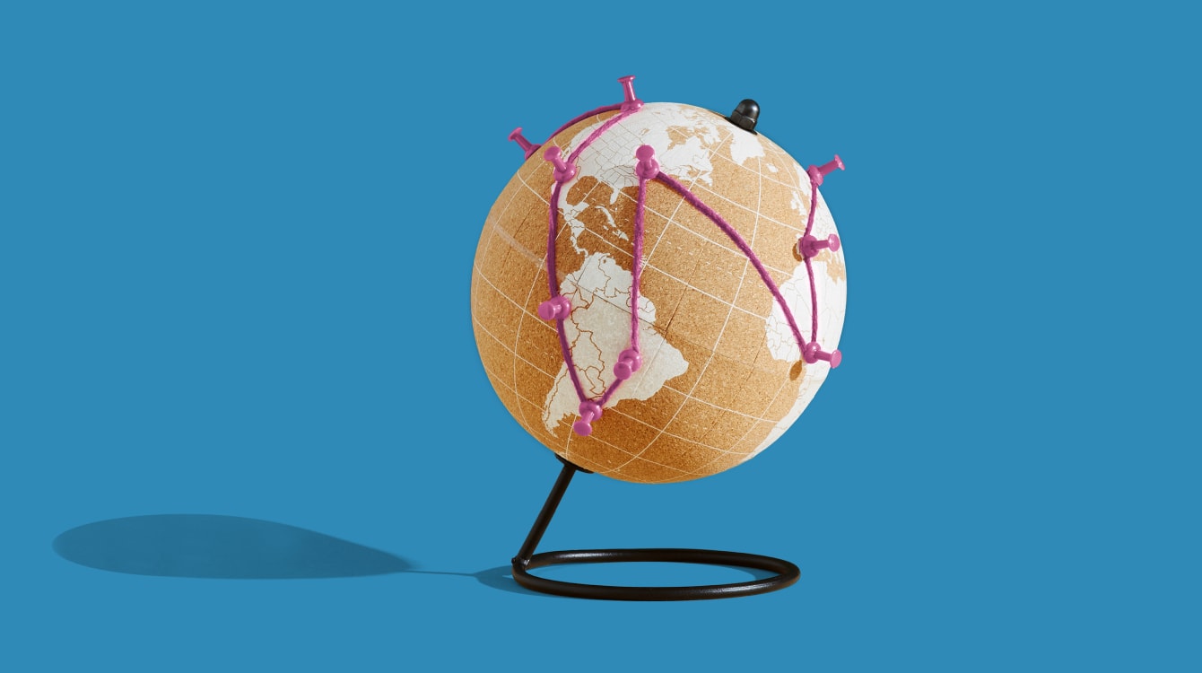 Globe with strings connecting different parts of the world representing the new world of work