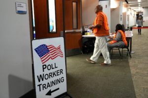 Election workers oversee early election voting at a polling station in Marietta